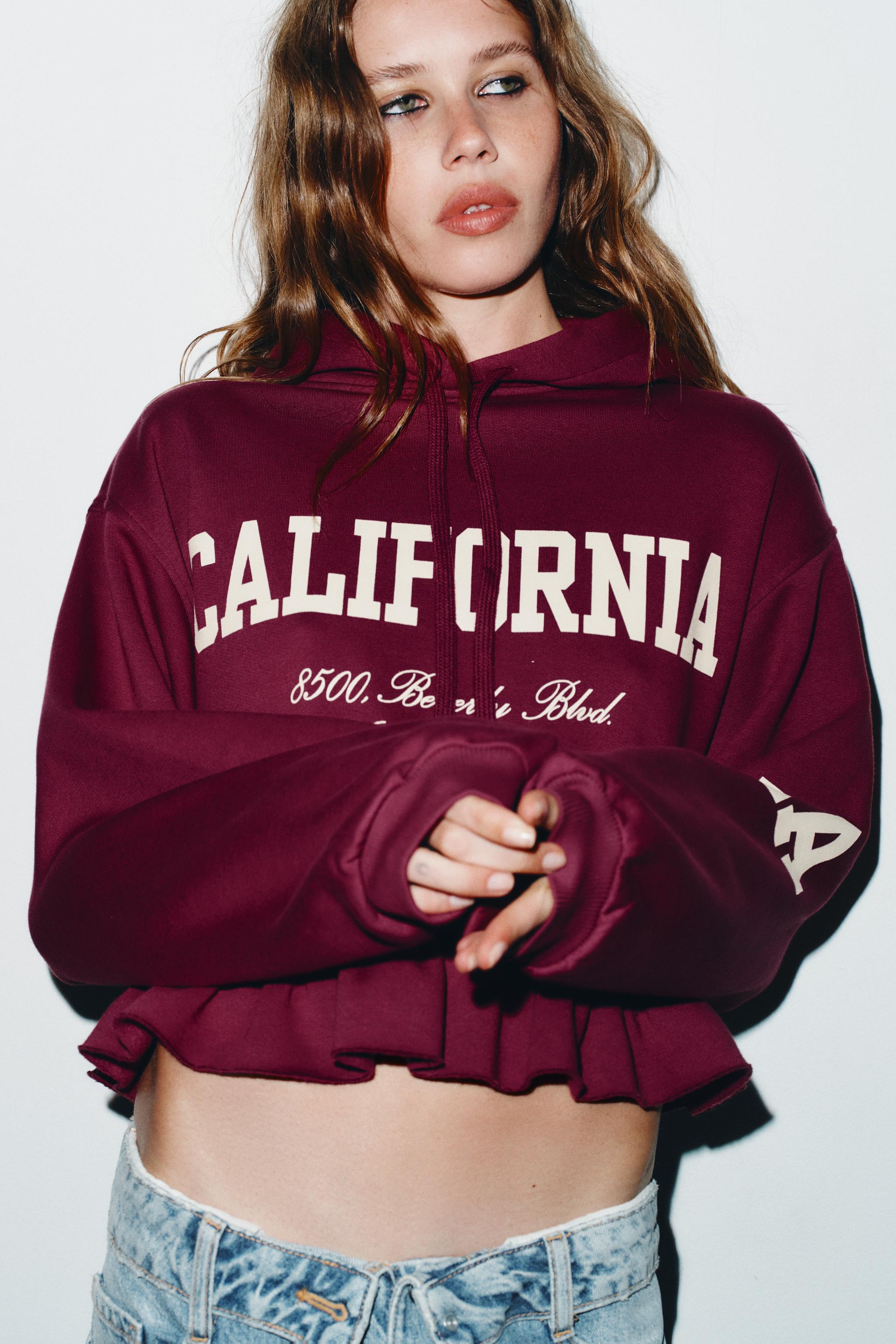 RUFFLED VARSITY SWEATSHIRT